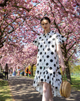 Polka Dot print dip hem dress with frill sleeves design in black white color