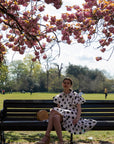 Polka Dot print dip hem dress with frill sleeves design in black white color