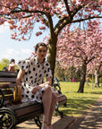 Polka Dot print dip hem dress with frill sleeves design in black white color